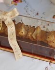 Caramelized Honey Pear Log Cake in Golden Lucite Dome